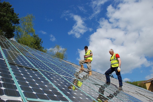 Gweithwyr yn archwilio Paneli Solar Ffotofoltaidd ar do